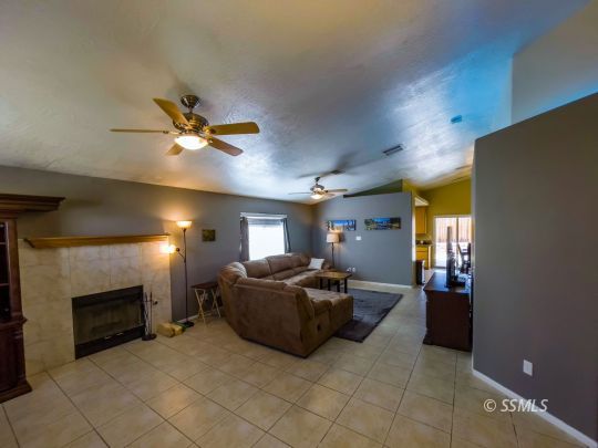 1411 Sims Street Ridgecrest, CA 93555 - Photo 5 of 35 a living room with furniture and a fireplace