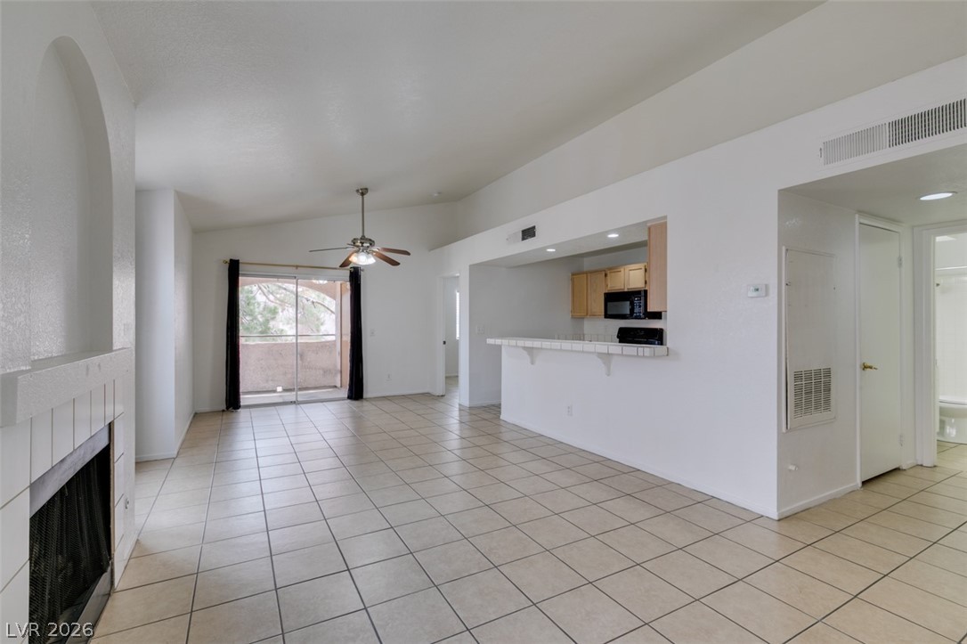 7570 West Flamingo Road, Unit 252 Las Vegas, NV 89147 - Photo 11 of 44 This living area features a corner fireplace, tiled floors, and an open layout to the kitchen.