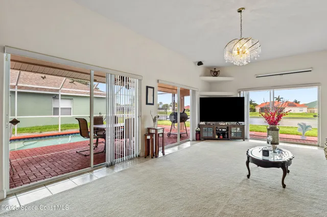 a room with pool table and windows