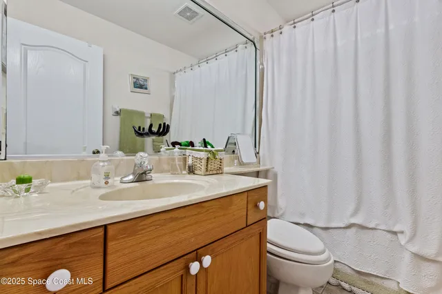 an aerial view of residential houses with outdoor space and lake view