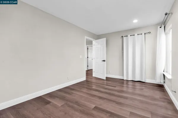 a view of wooden floor and windows in a room