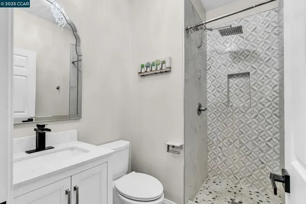 a bathroom with a shower toilet and sink