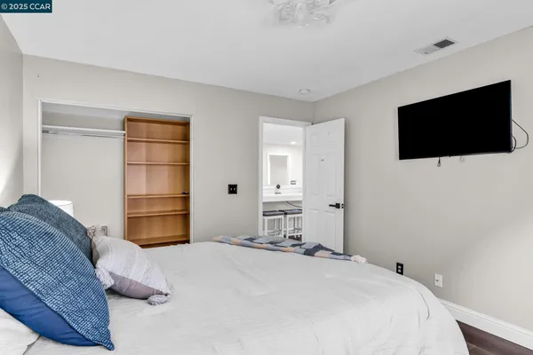 a bedroom with a bed and a flat screen tv