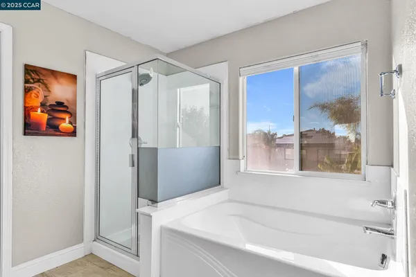 a bathroom with a bathtub and a shower