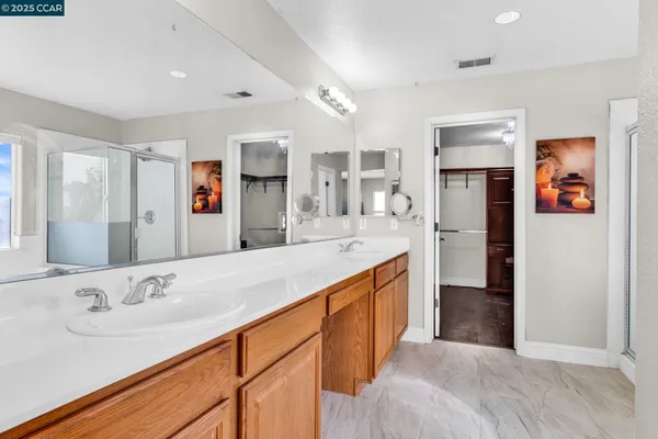a spacious bathroom with a sink double vanity and a mirror