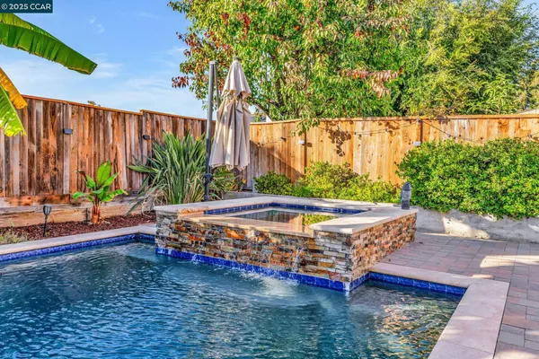 a large tree in the garden is sitting in front of a house