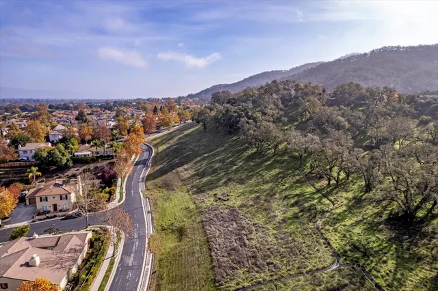 an aerial view of a residential houses with city view
