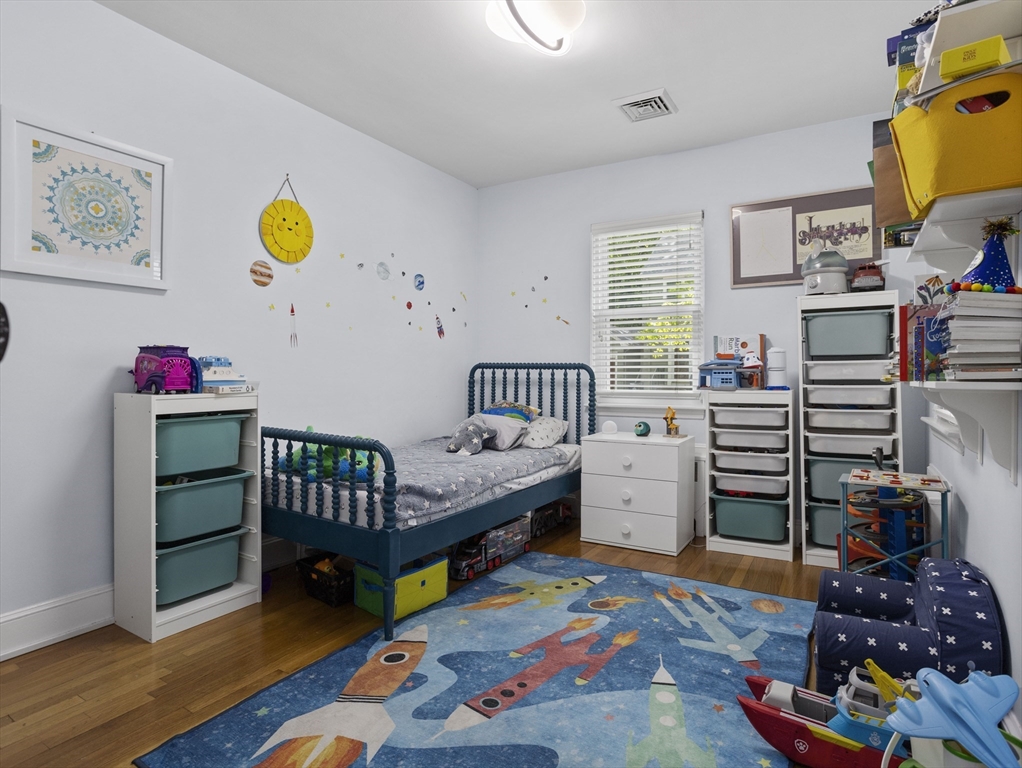 29 Payson Road Brookline, MA 02467 - Photo 12 of 28 a bedroom with furniture and a wooden floor