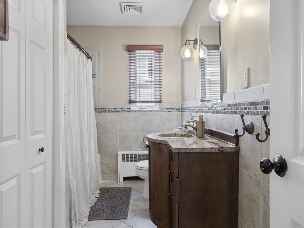 29 Payson Road Brookline, MA 02467 - Photo 13 of 28 a bathroom with a tub sink and mirror
