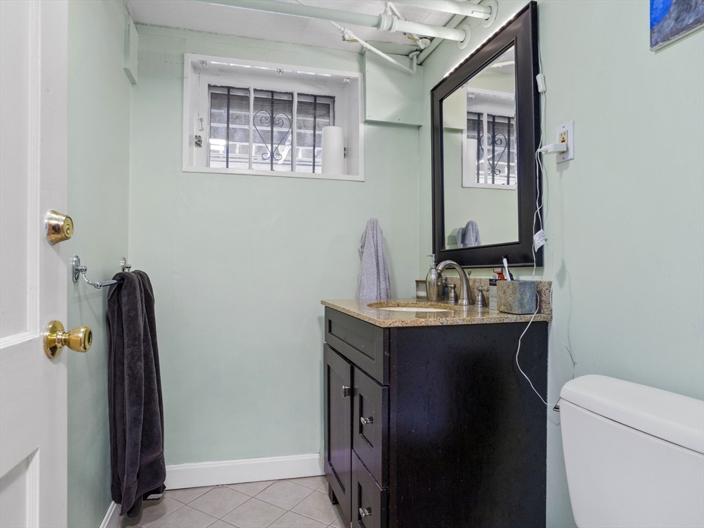 29 Payson Road Brookline, MA 02467 - Photo 15 of 28 a bathroom with a sink a mirror and a toilet