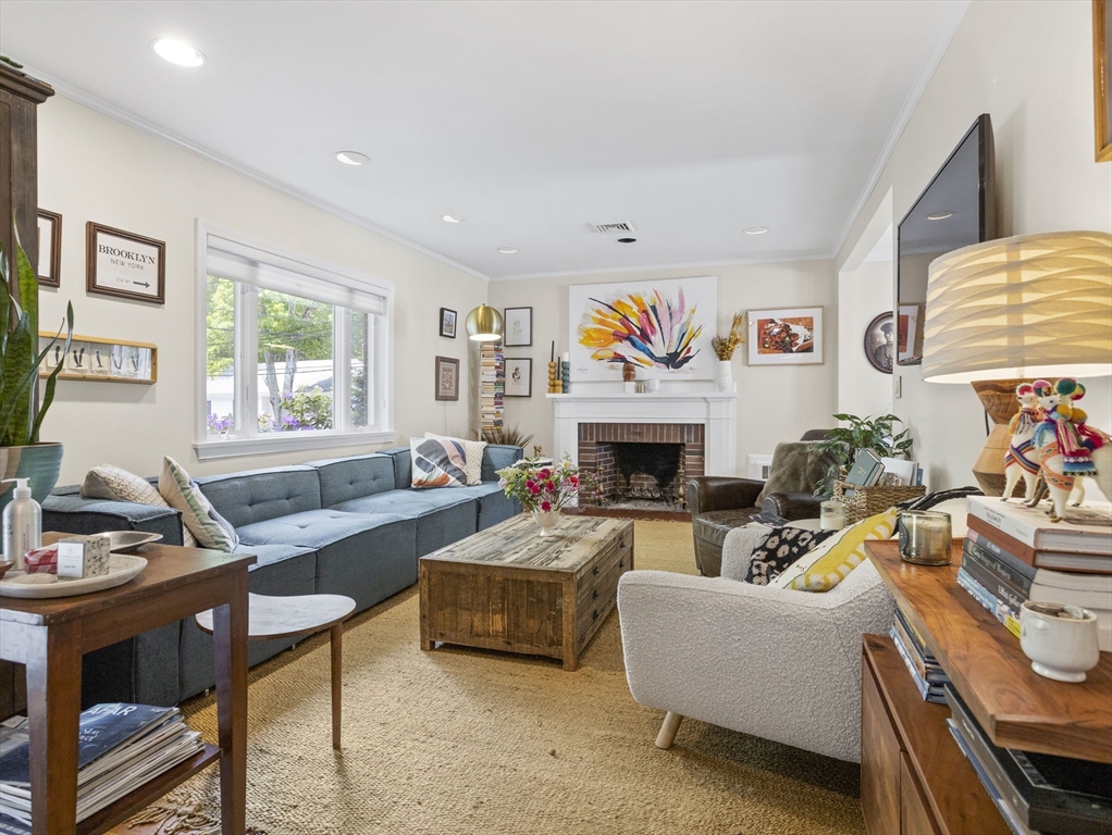 29 Payson Road Brookline, MA 02467 - Photo 2 of 28 a living room with furniture a flat screen tv and a fireplace