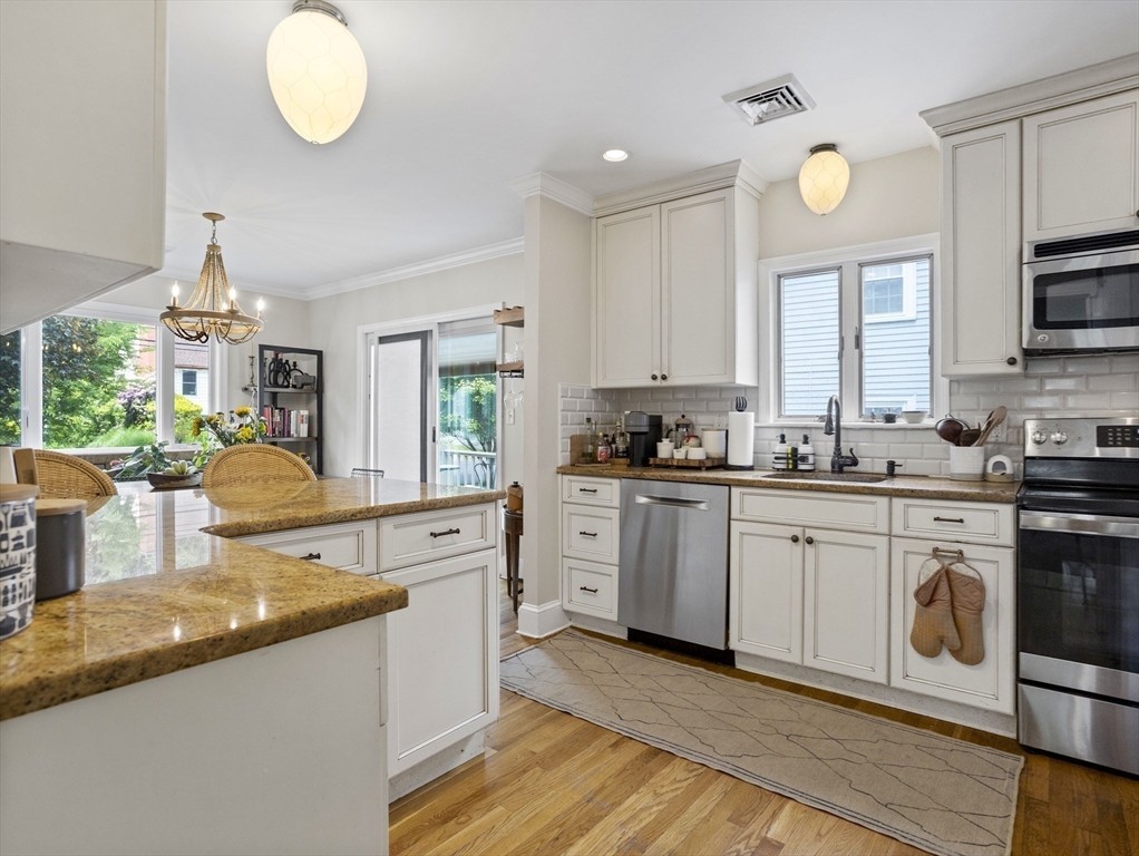 29 Payson Road Brookline, MA 02467 - Photo 7 of 28 a kitchen with stainless steel appliances granite countertop a stove a sink and a granite counter tops with white cabinets