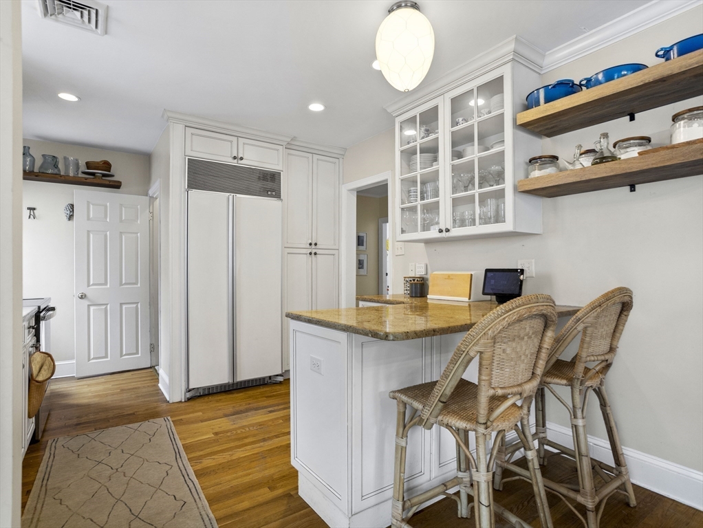 29 Payson Road Brookline, MA 02467 - Photo 9 of 28 a kitchen with granite countertop kitchen island stainless steel appliances a table and chairs