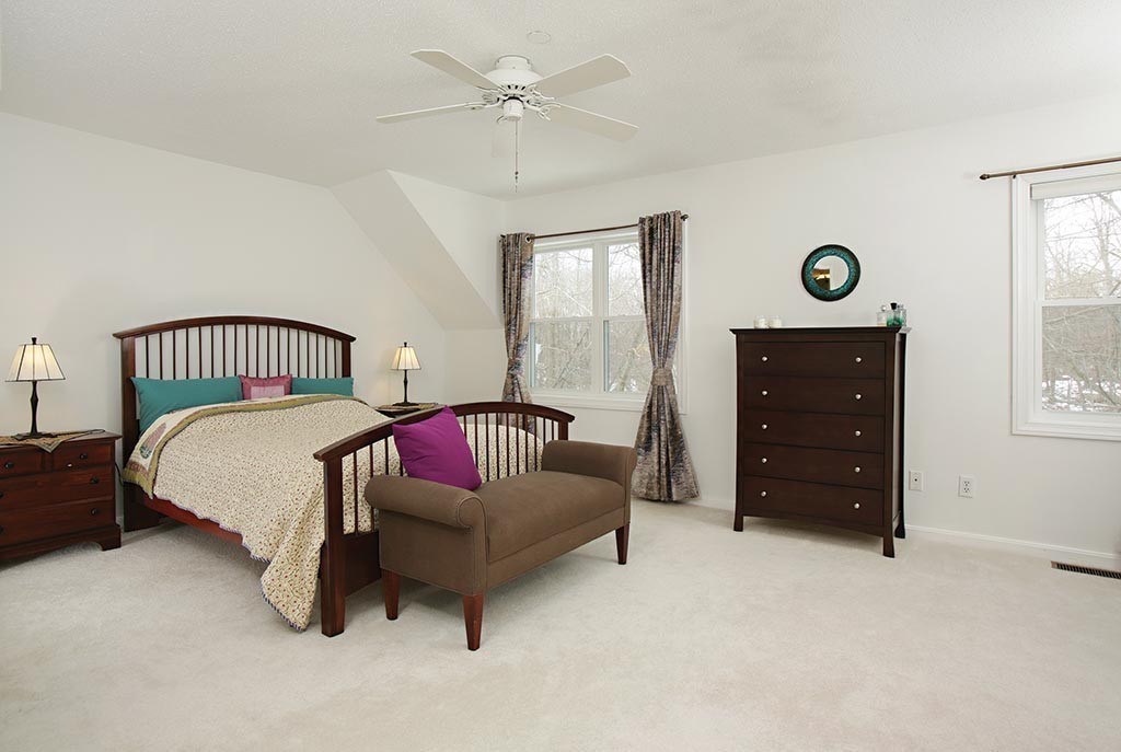 9 Maple Ridge Drive, Unit 9 Burlington, MA 01803 - Photo 7 of 11 a bedroom with a bed and a closet