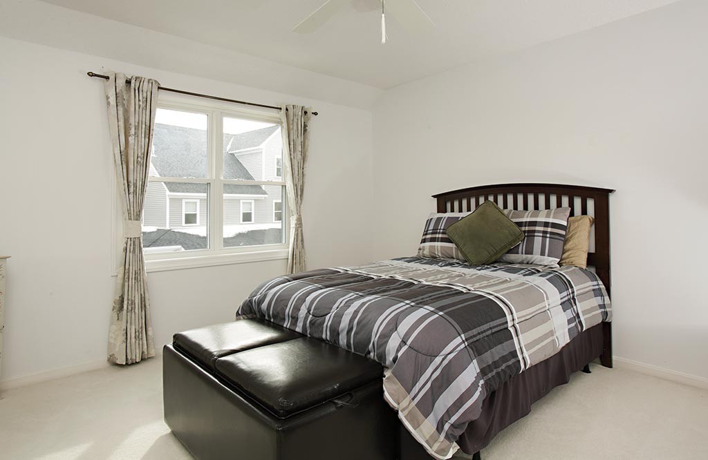 9 Maple Ridge Drive, Unit 9 Burlington, MA 01803 - Photo 8 of 11 a bedroom with a bed and with a window