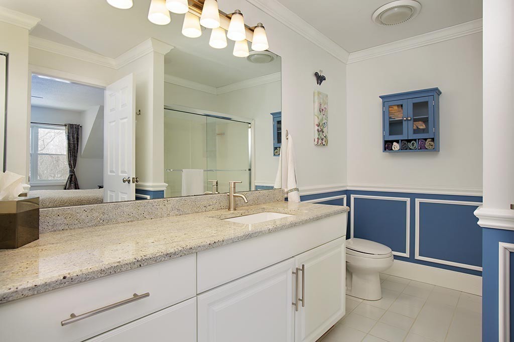 9 Maple Ridge Drive, Unit 9 Burlington, MA 01803 - Photo 9 of 11 a bathroom with a granite countertop toilet sink and mirror