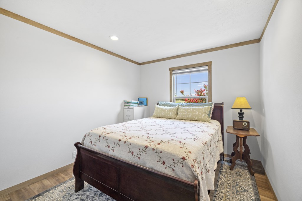 64 Scott Branch Road Harper, TX 78631 - Photo 18 of 36 a bedroom with a bed and a lamp on table