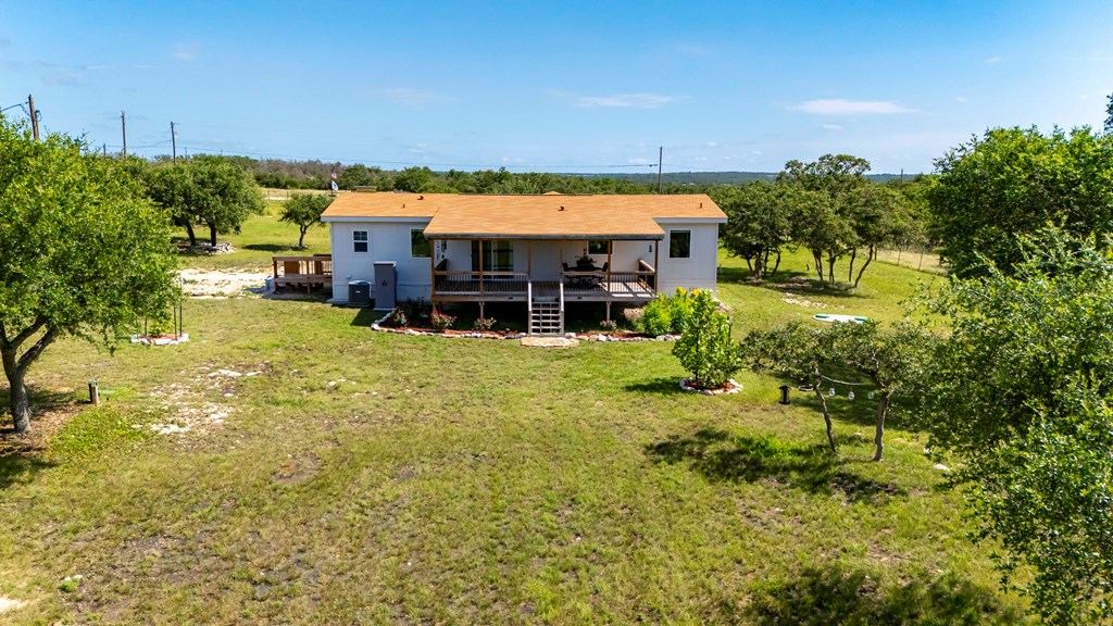 64 Scott Branch Road Harper, TX 78631 - Photo 23 of 36 a view of a house with a garden and sitting area