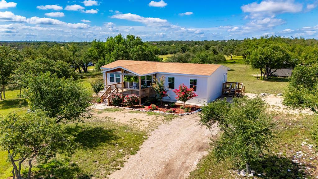 64 Scott Branch Road Harper, TX 78631 - Photo 3 of 36 a view of a house with a big yard plants and large tree