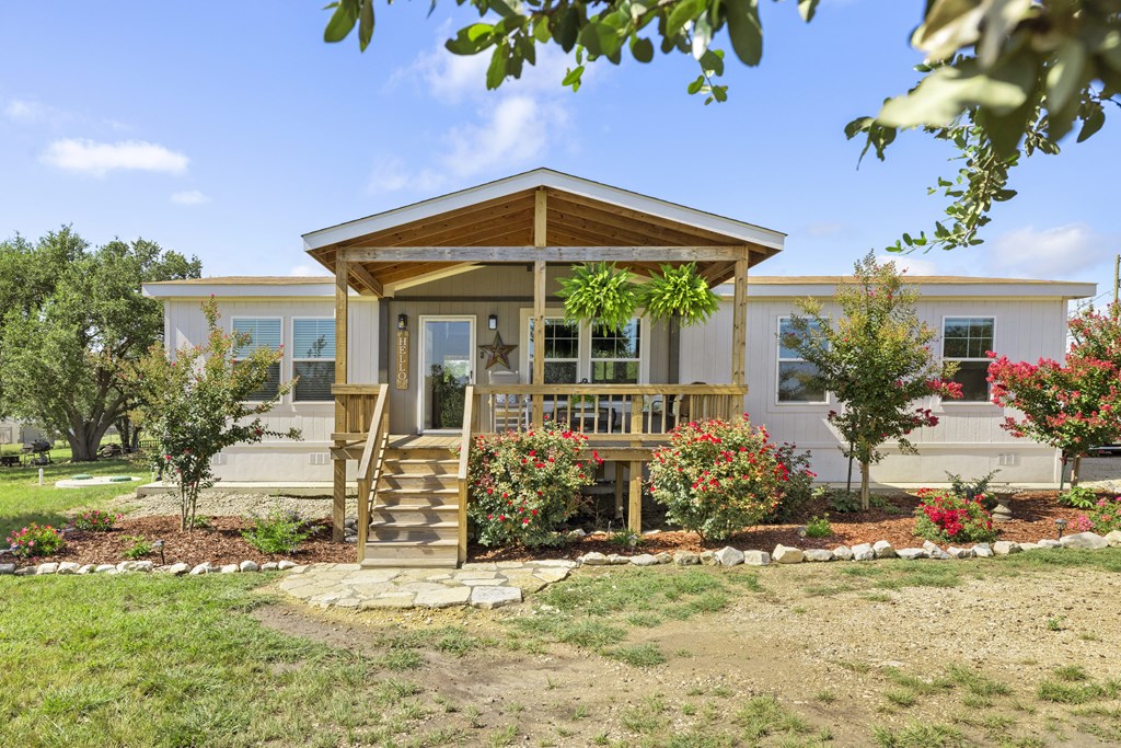 64 Scott Branch Road Harper, TX 78631 - Photo 5 of 36 a front view of a house with garden