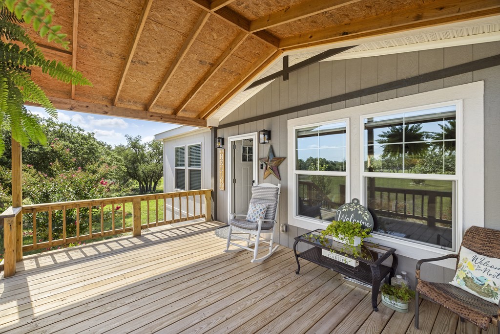 64 Scott Branch Road Harper, TX 78631 - Photo 6 of 36 a balcony with wooden floor and furniture