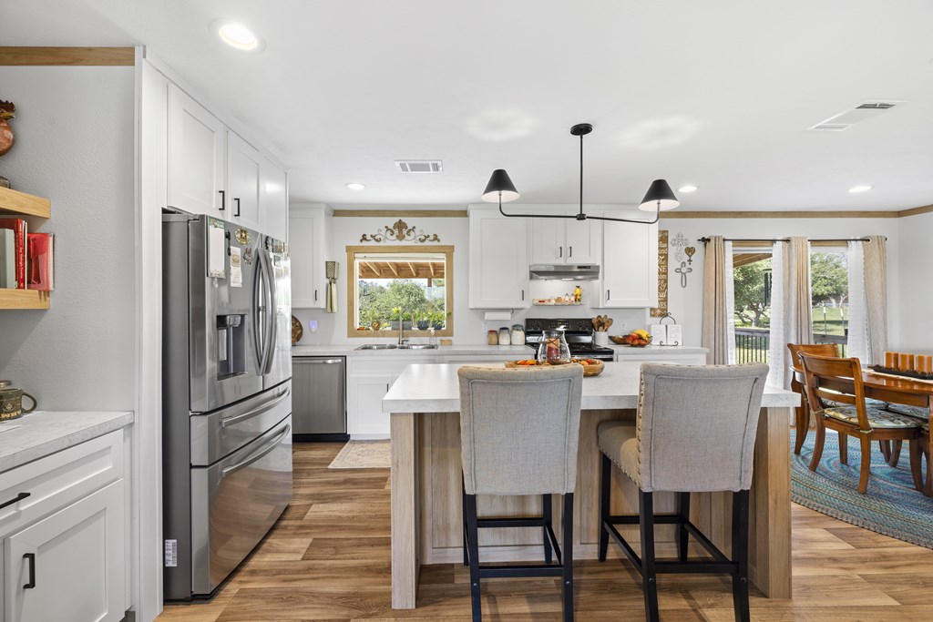 64 Scott Branch Road Harper, TX 78631 - Photo 10 of 36 a view of a dining room with furniture window and wooden floor