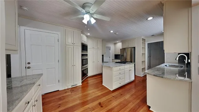 a kitchen with white cabinets and stainless steel appliances