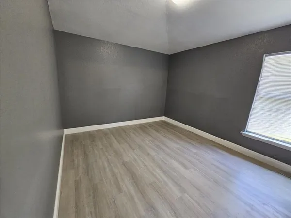 a view of wooden floor in an empty room