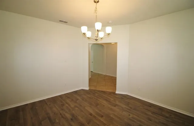 a view of a chandelier fan and wooden floor