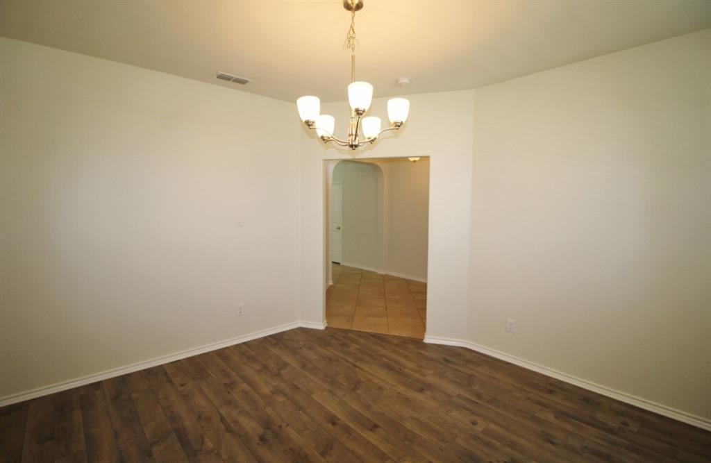 1205 Crest Ridge Drive Glenn Heights, TX 75154 - Photo 12 of 27 a view of a chandelier fan and wooden floor