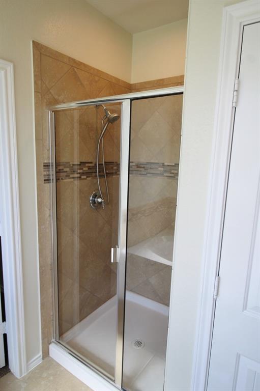1205 Crest Ridge Drive Glenn Heights, TX 75154 - Photo 18 of 27 a bathroom with a glass shower door