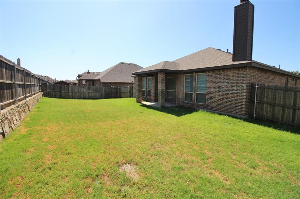 1205 Crest Ridge Drive Glenn Heights, TX 75154 - Photo 26 of 27 a view of a house with a yard