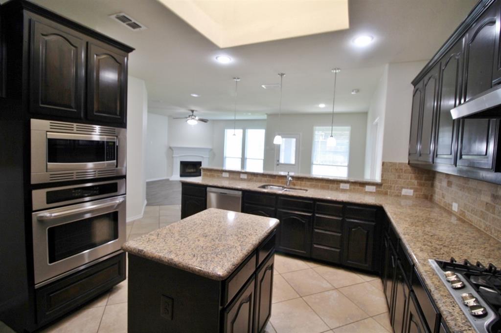 1205 Crest Ridge Drive Glenn Heights, TX 75154 - Photo 5 of 27 a kitchen with a sink and stainless steel appliances