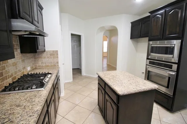 a kitchen with a stove and a microwave