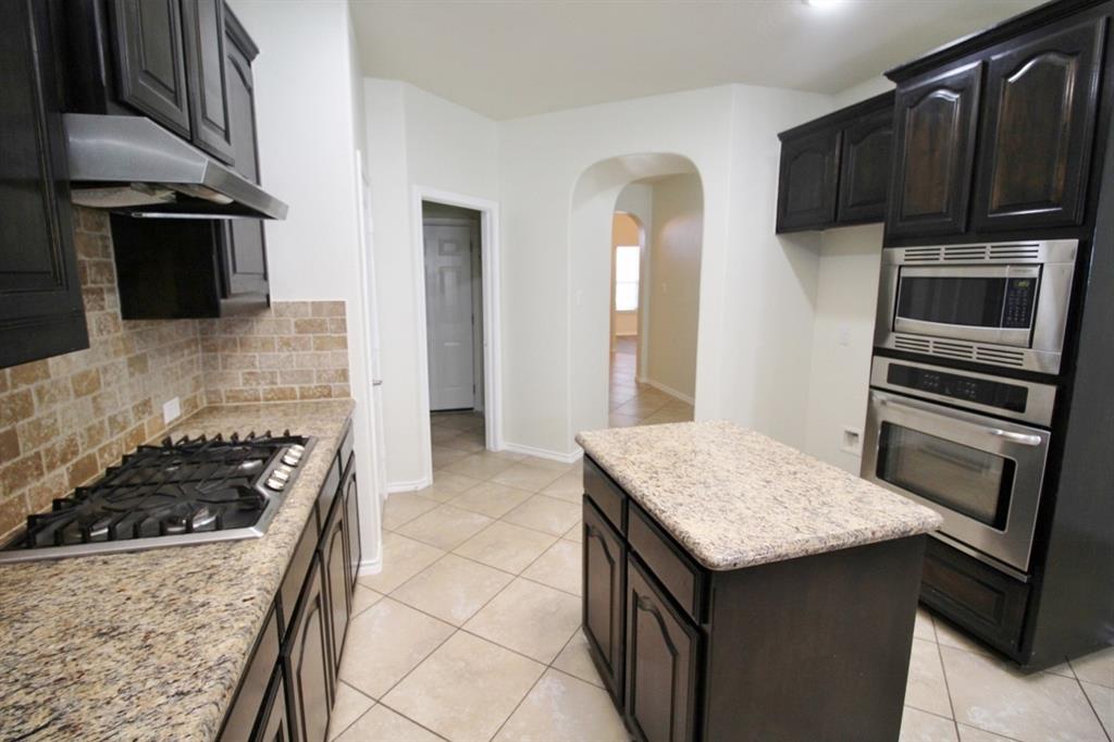 1205 Crest Ridge Drive Glenn Heights, TX 75154 - Photo 6 of 27 a kitchen with a stove and a microwave