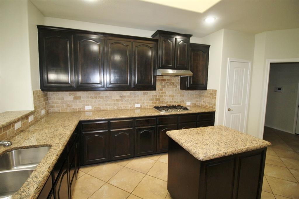 1205 Crest Ridge Drive Glenn Heights, TX 75154 - Photo 7 of 27 a kitchen with a sink and cabinets