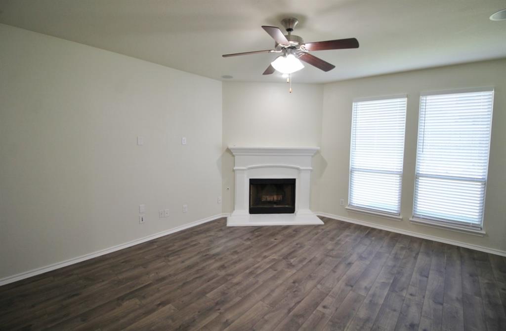 1205 Crest Ridge Drive Glenn Heights, TX 75154 - Photo 9 of 27 a view of empty room with wooden floor and fan