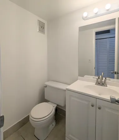 a bathroom with a sink a toilet and mirror