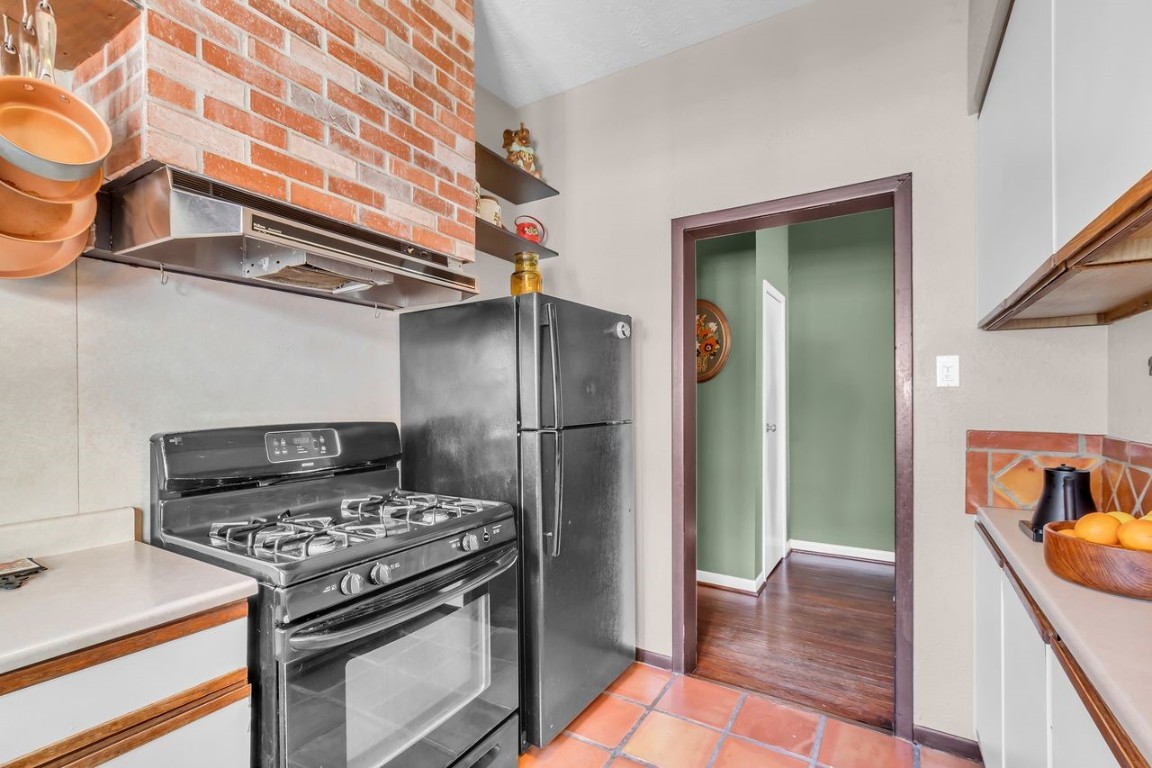 2608 Hopkins Street Houston, TX 77006 - Photo 22 of 35 a kitchen with stainless steel appliances granite countertop a stove and a refrigerator