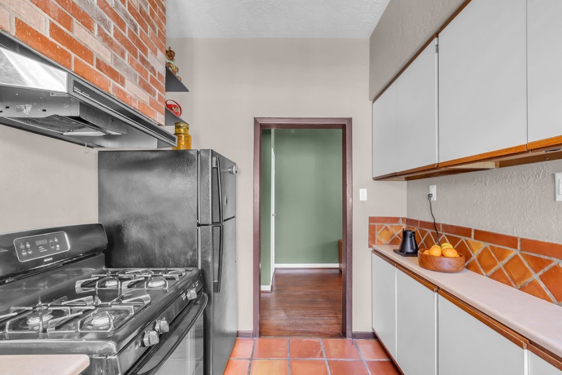 2608 Hopkins Street Houston, TX 77006 - Photo 23 of 35 a kitchen with a stove and a refrigerator