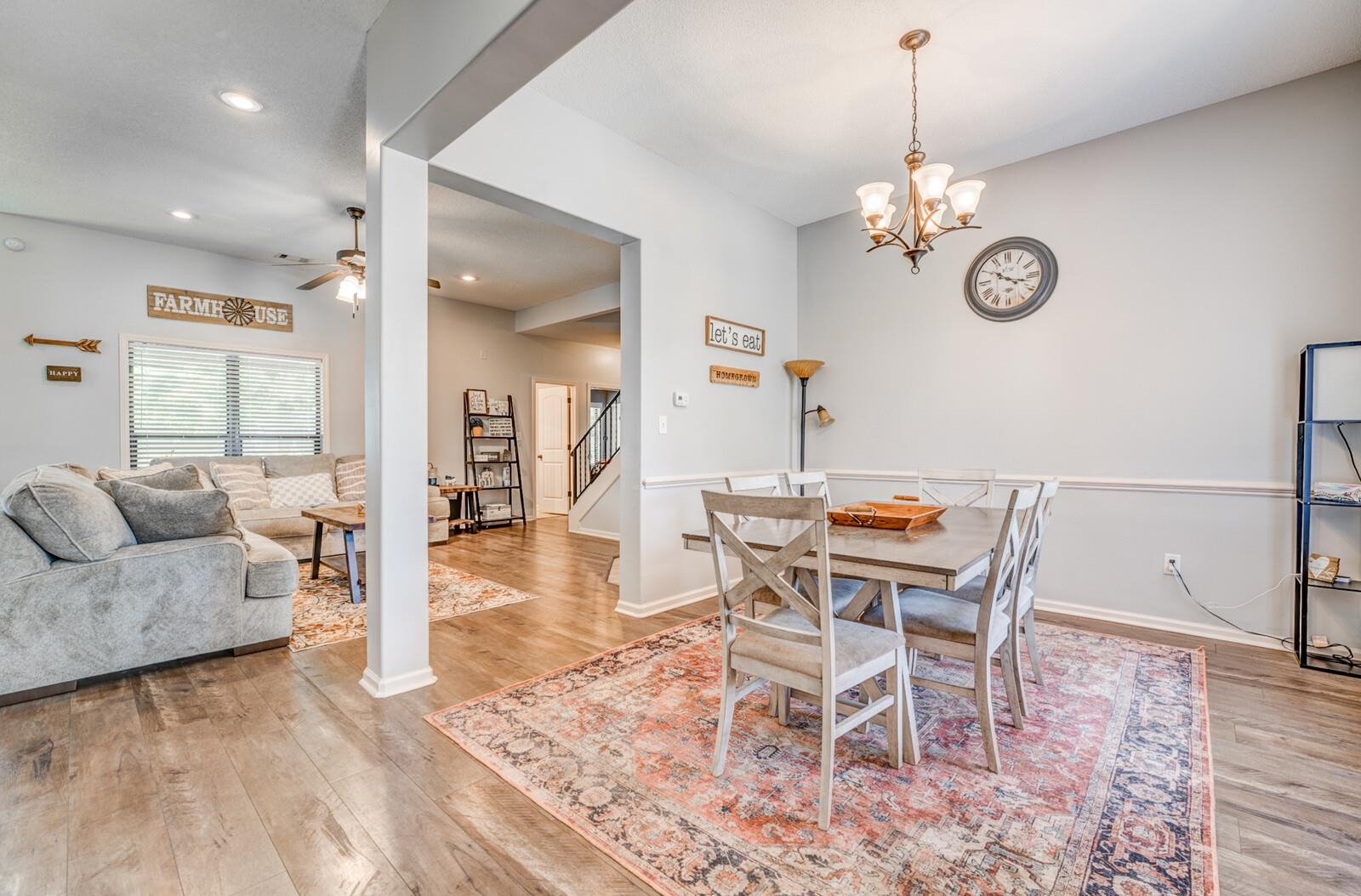 4671 Hampton Ridge Lane Bartlett, TN 38002 - Photo 9 of 40 Dining area featuring an ornate chandelier, chair rail molding, and wood-finish flooring