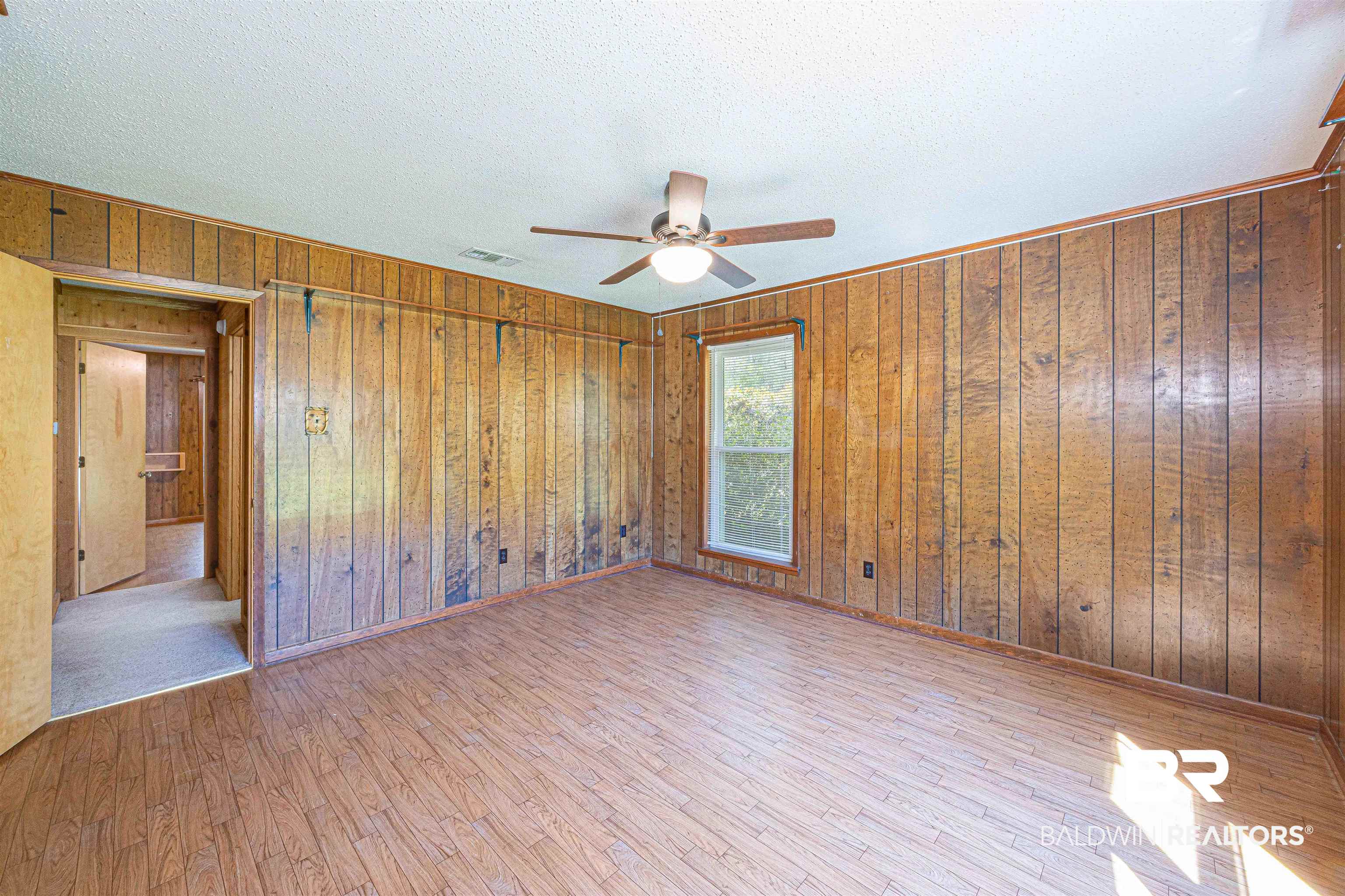 43101 Brown Road Bay Minette, AL 36507 - Photo 46 of 81 Spare room featuring light wood-style flooring, a ceiling fan, a textured ceiling, and wood walls
