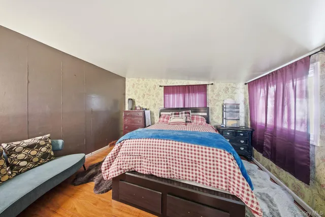 a bedroom with a bed and window