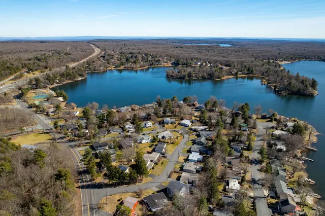an aerial view of a houses with a lake view
