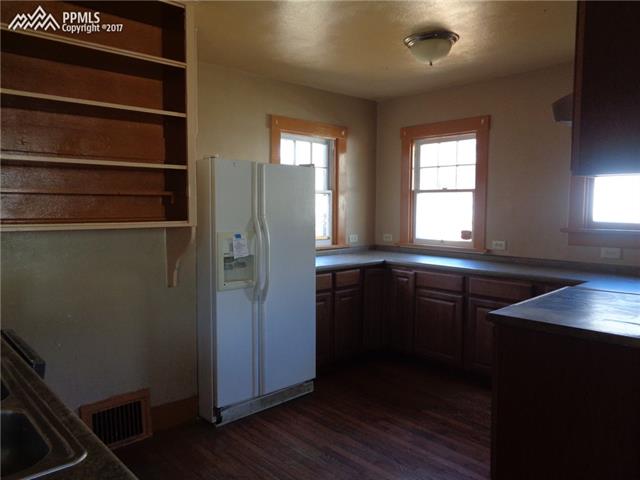 318 West Cheyenne Road Colorado Springs, CO 80906 - Photo 8 of 36 Main house: Kitchen. Notice the large windows and lots of counter space, cabinets and shelving.