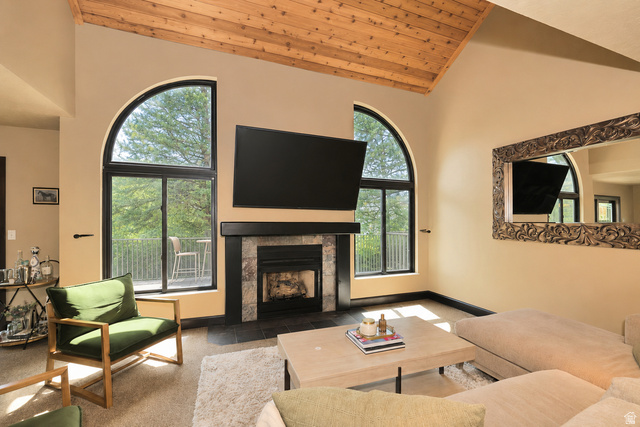 3104 East High Danish Road Sandy, UT 84093 - Photo 5 of 36 Vaulted wood-finish ceiling above a stone-surround fireplace with a dark wood mantel