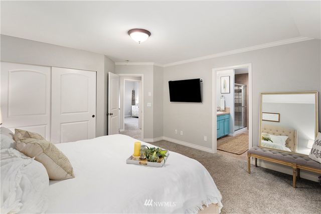 a bedroom with a bed and a flat screen tv