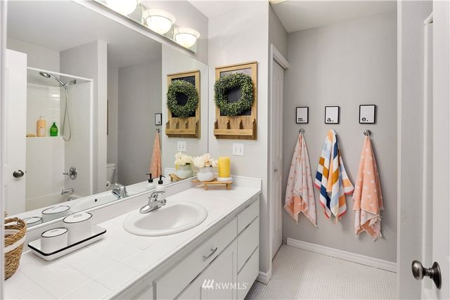 a bathroom with a sink mirror and vanity