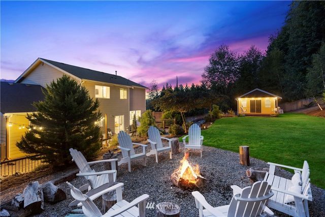 a view of a house with backyard porch and sitting area