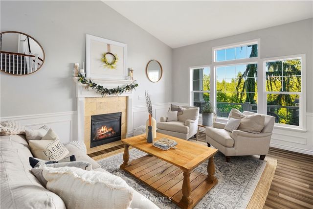 a living room with furniture fireplace and window